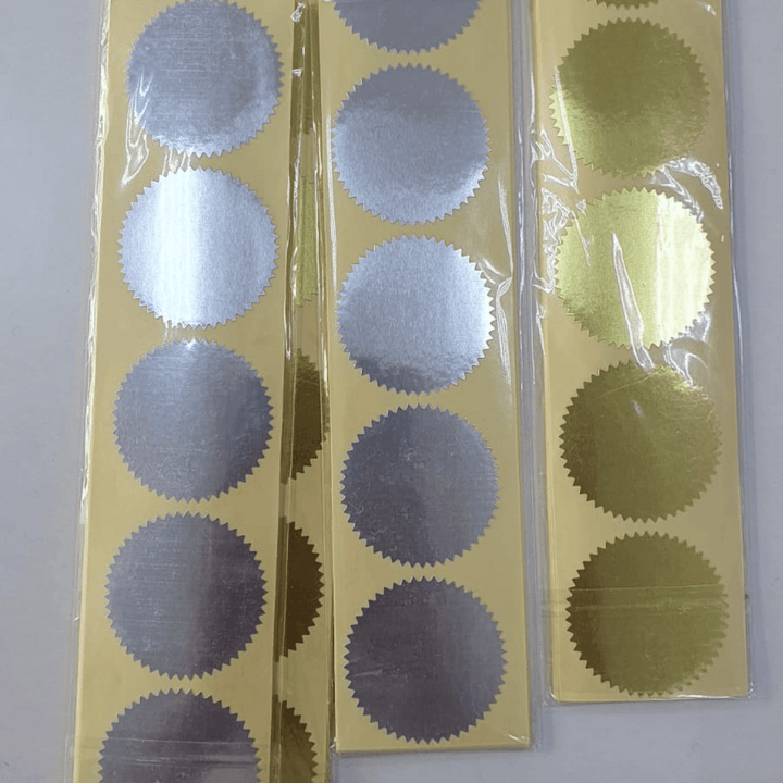 Custom embosser seal pressing a raised logo into paper in Umm Al Quwain